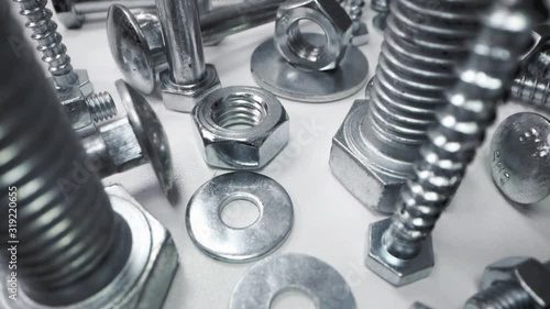 variety of metal screws and fasteners. dolly shot photo