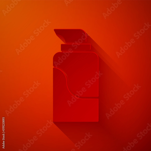Paper cut Cream or lotion cosmetic tube icon isolated on red background. Body care products for men. Paper art style. Vector Illustration