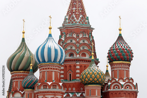 St. Basil's Cathedral against the winter sky, close-up of domes covered with snow. Russian architecture landmark, located on Red square in Moscow