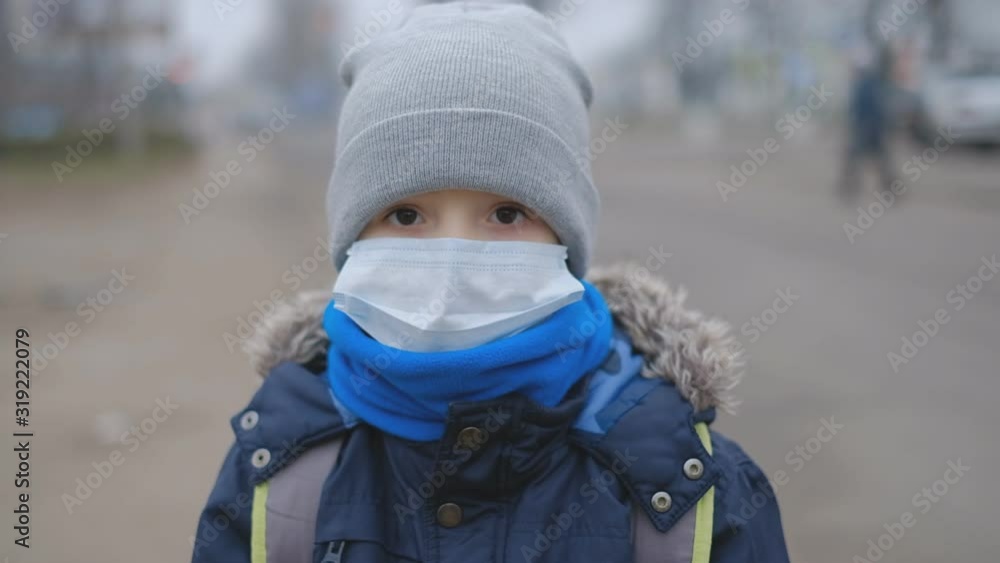 Chinese coronavirus in Europe. The epidemic in Europe. A little boy defends himself from a coronavirus in a medical mask in a public place. Chinese coronavirus in Europe. The epidemic in Europe. A little boy defends himself from a coronavirus in a medical mask in a public place.