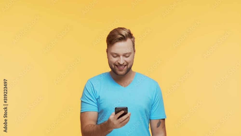 Expressive young man with a smartphone over vibrant background. Portrait of handsome person. Expressive young man with a smartphone over vibrant background. Portrait of handsome person.