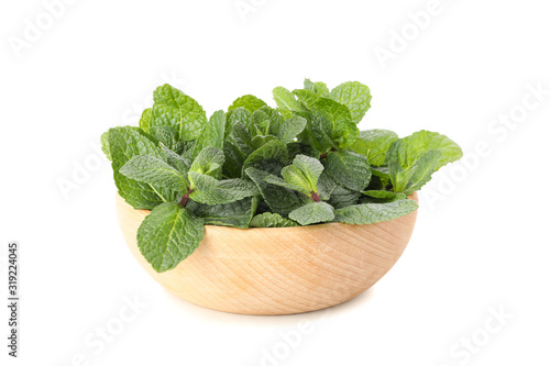 Wooden bowl with mint isolated on white background