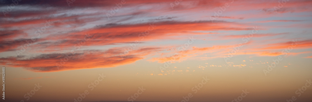 Long horizontal BANNER. Sunset sky with long pink clouds