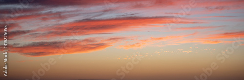 Long horizontal BANNER. Sunset sky with long pink clouds