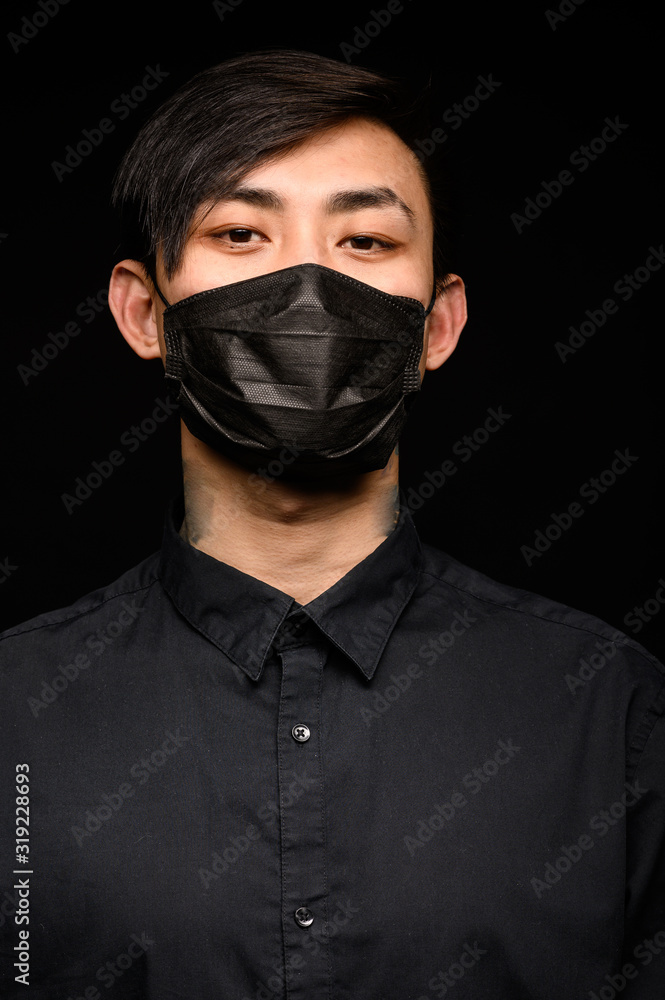 Asian in black medical mask. Coronavirus is a virus that is endemic in China. Asian in black medical mask. Coronavirus is a virus that is endemic in China.