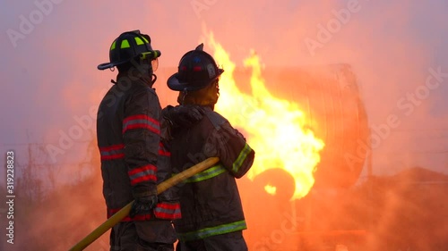 Firefighters and extinguish the burning fire.