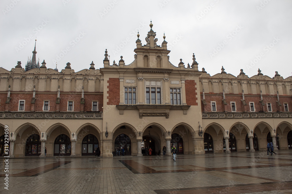 Fototapeta premium Market Square in Krakow for Catholic Christmas with the Christmas market, Rows of rows, Mariinsky Church and the Town Hall.