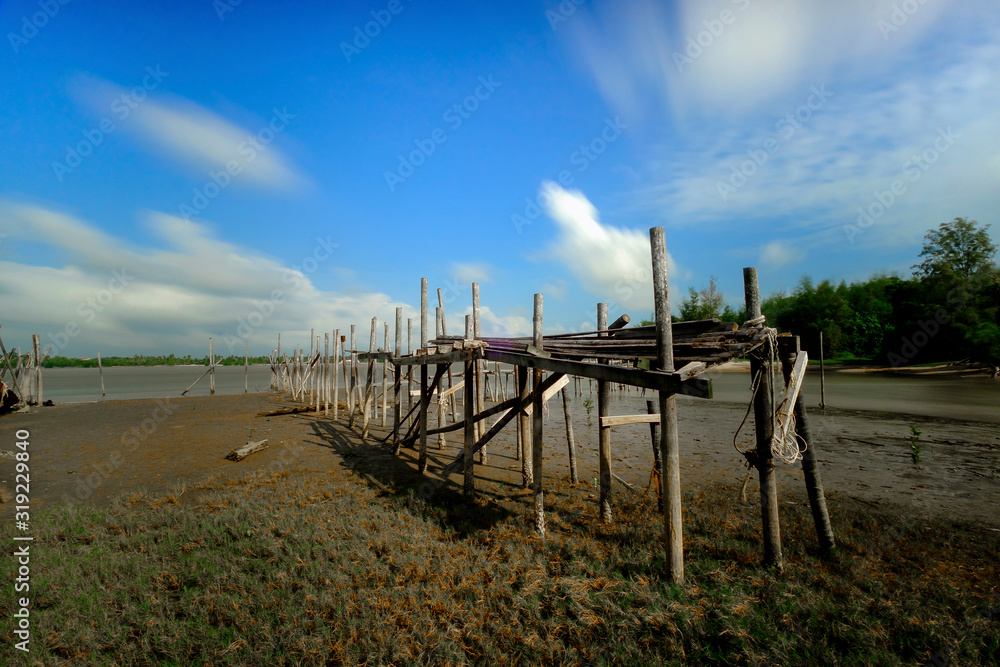 Old wood jetty at Kuala Rompin, Malaysia with beautiful blue sky