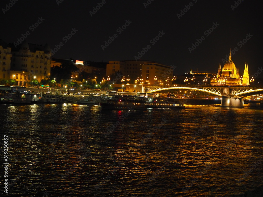 A beautiful night panorama of Budapest the capital of Hungary with Danube river and illuminated bridge and Parliament in summer