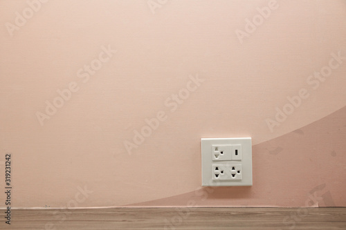 Plug Socket on the Wall with Pastel Background/Flower