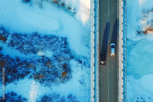 Car rides on a bridge over ravine, view from above.