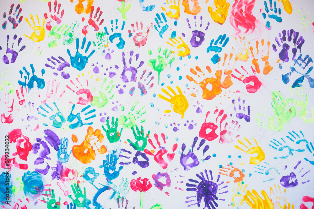 White wall with colorful multicolored hand prints print