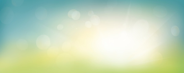 A fresh spring blue sunny sky background with blurred warm sunny glow.