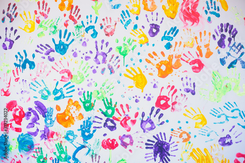 White wall with colorful multicolored hand prints print