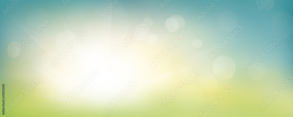 A fresh spring blue sunny sky background with blurred warm sunny glow.