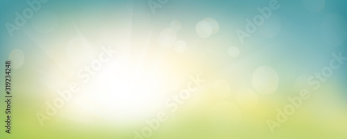 Obraz na płótnie A fresh spring blue sunny sky background with blurred warm sunny glow. w salonie
