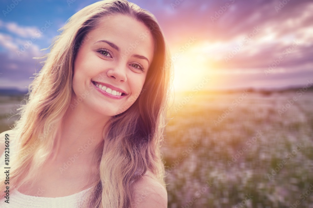 Young woman on field under sunset light