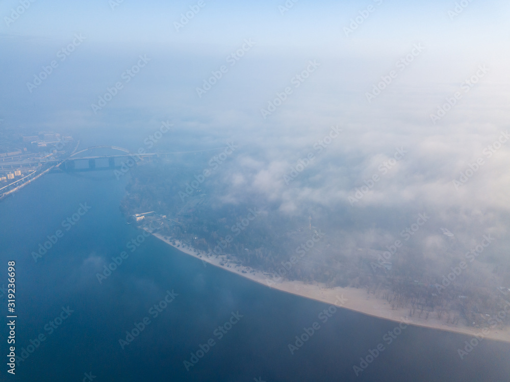 Aerial drone view. View of the island covered in fog.