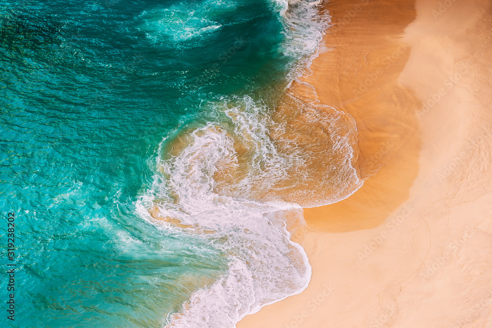Aerial view of the turquoise ocean waves on the beach. Beautiful sandy beach with turquoise sea. Lonely sandy beach with beautiful waves. Beaches In Australia. Empty Ocean View from above.