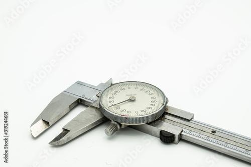 Фотография A dial caliper lying on a white background
