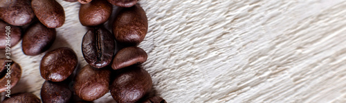 Banner of Coffee beans or grain on white wooden background.