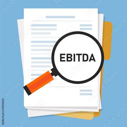 EBITDA Earnings before interest, tax, depreciation and amortization. magnifying glass and paper of financial statement with acronym inside photo
