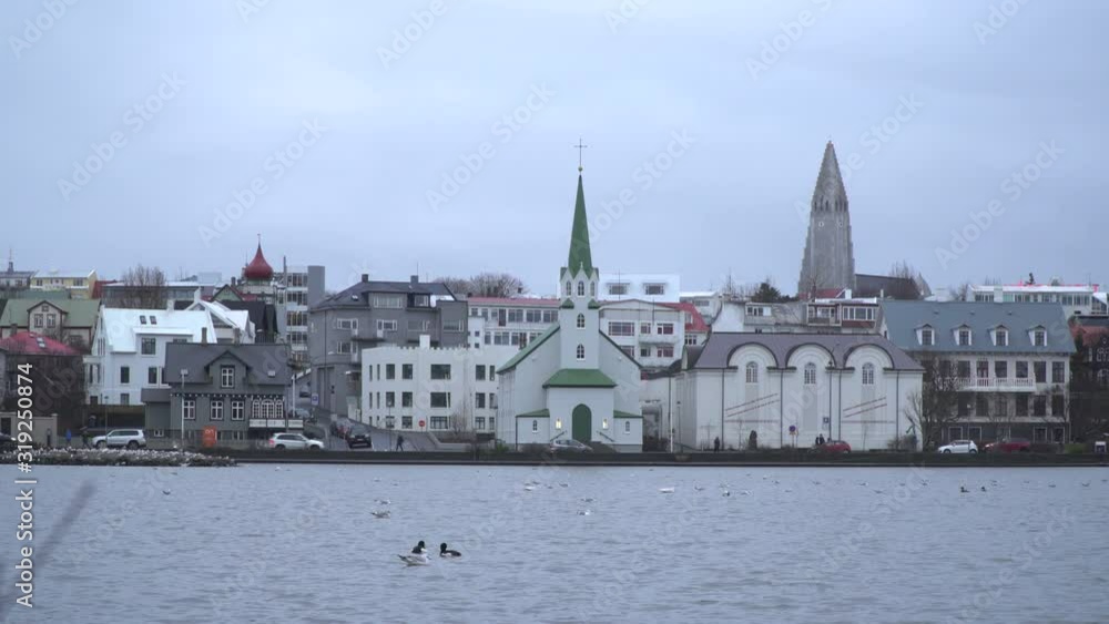 4K: Reykjavik, Iceland skyline / cityscape with churches behind pond / lake 4K: Reykjavik, Iceland skyline / cityscape with churches behind pond / lake
