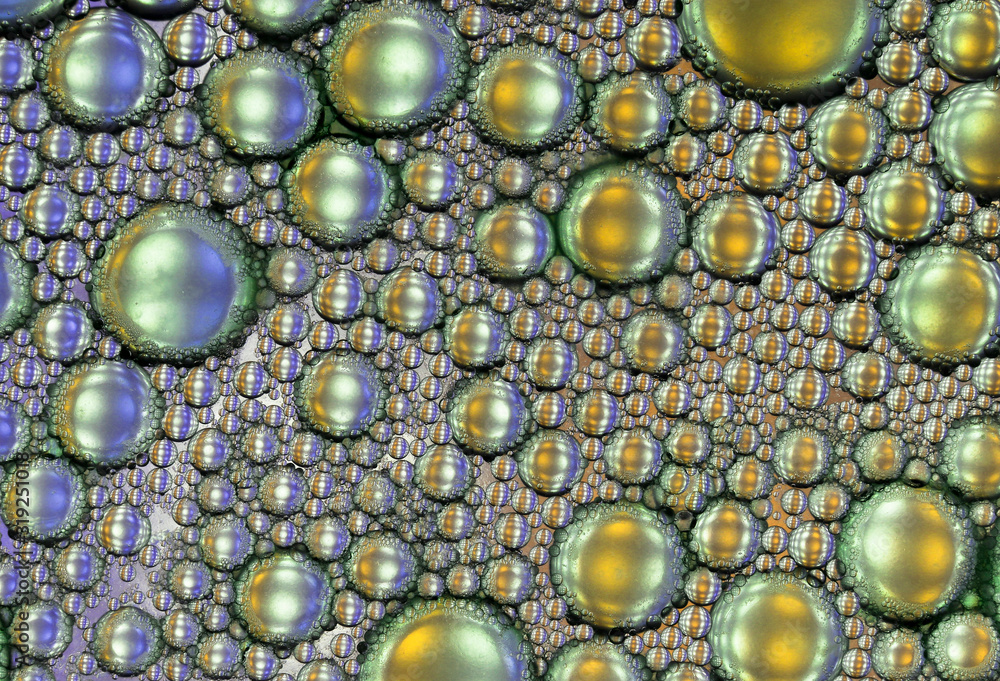 Oil and water abstract macro texture in blue and gold as a background Oil and water abstract macro texture in blue and gold as a background