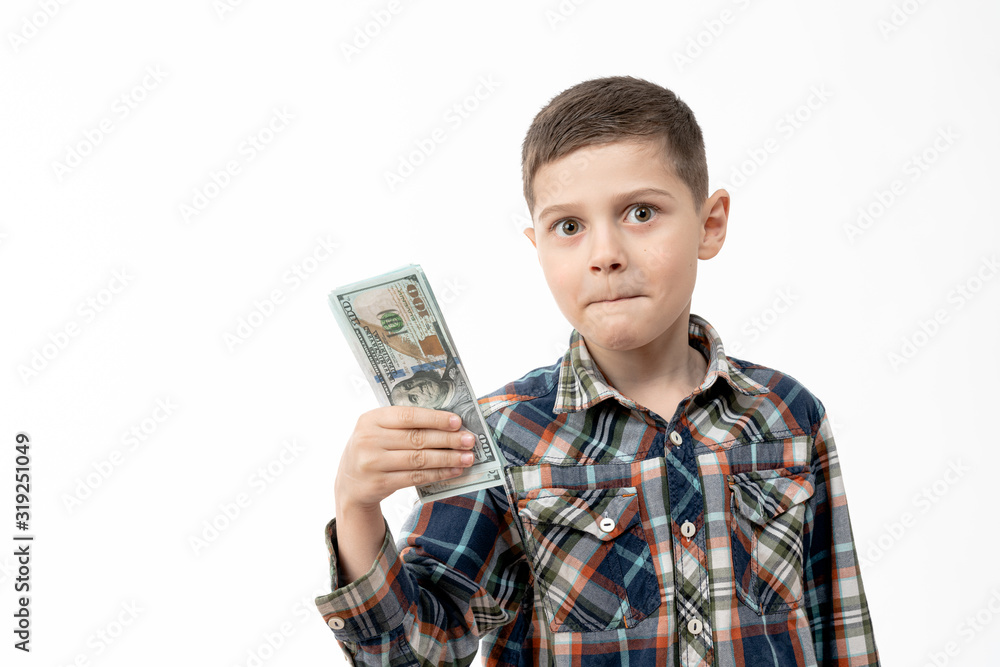 Excited, handsome little boy in shirt holds banknotes in his hand and looking at the camera isolated over white background Excited, handsome little boy in shirt holds banknotes in his hand and looking at the camera isolated over white background