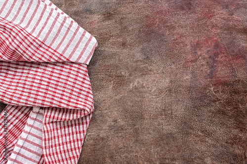 Red-white checkered napkin on a dark vintage background. View from above