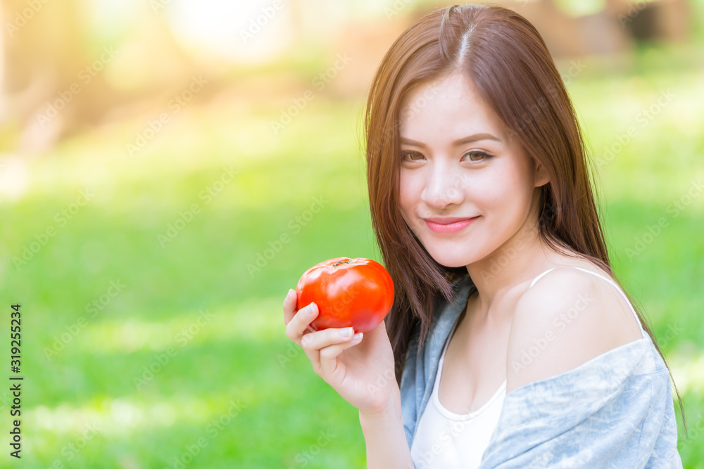 Asian Women with Tometo for healthy vegetable food high beta carotene vitamin for good health skin concept. Asian Women with Tometo for healthy vegetable food high beta carotene vitamin for good health skin concept.