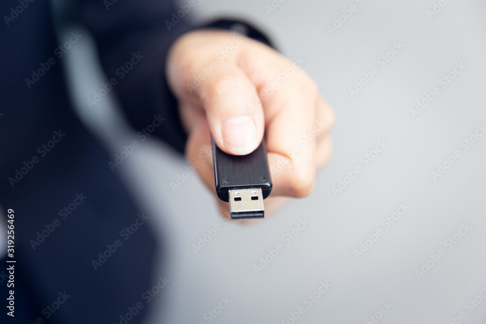 Closeup user hand plug insert USB flash drive type A male device. - obrazy, fototapety, plakaty 