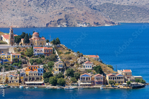 Fototapeta Naklejka Na Ścianę i Meble -  The picturesque coastline of Symi with beautiful old houses, Symi island, Dodecanese, Greece