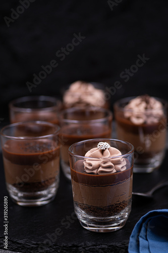 Chocolate mousse in glasses topped with whipped cream