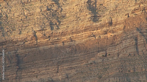 Sunlights on mountain canyon, Stone texture on a mountain face in early morning light, sedimentary mountain limestone rocks texture