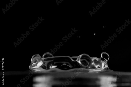 Water splash isolated, water drop hit the surface, water droplet falling and hitting water surface and causing a rebound and explosion
