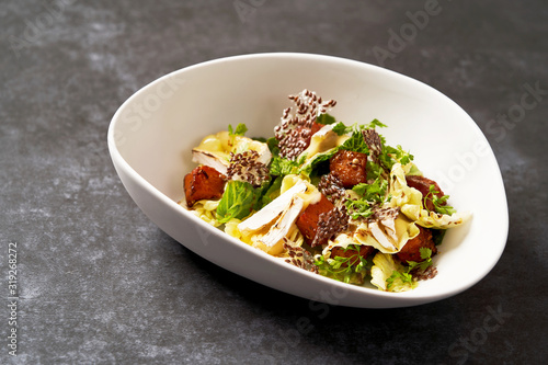 Baked Pumpkin salad with baked cheese, parsley herbs, white cabbage