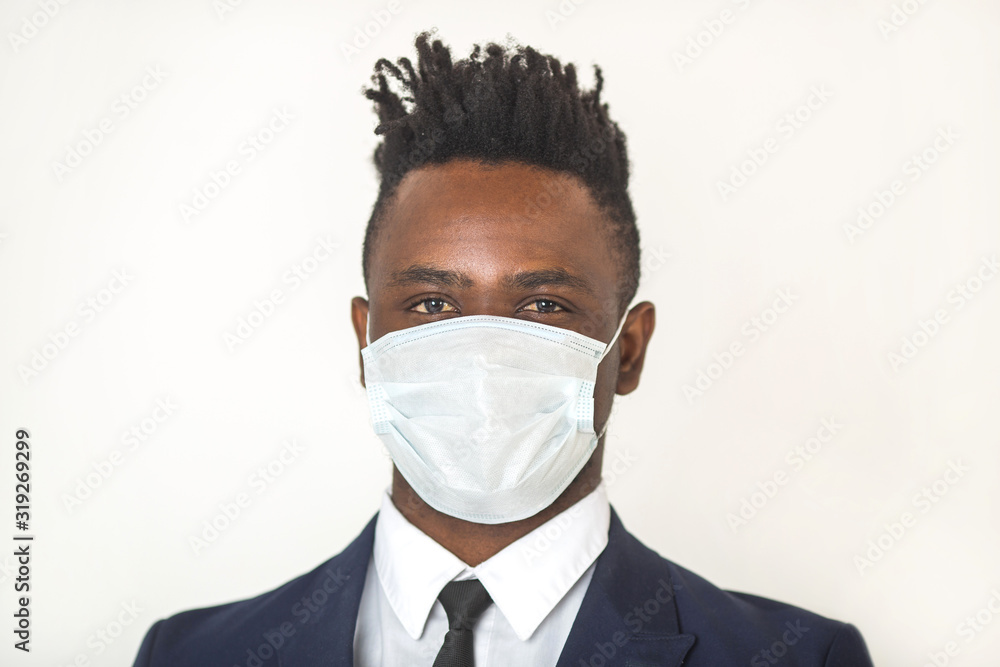 young african man in antivirus gauze mask on his face on a white background young african man in antivirus gauze mask on his face on a white background