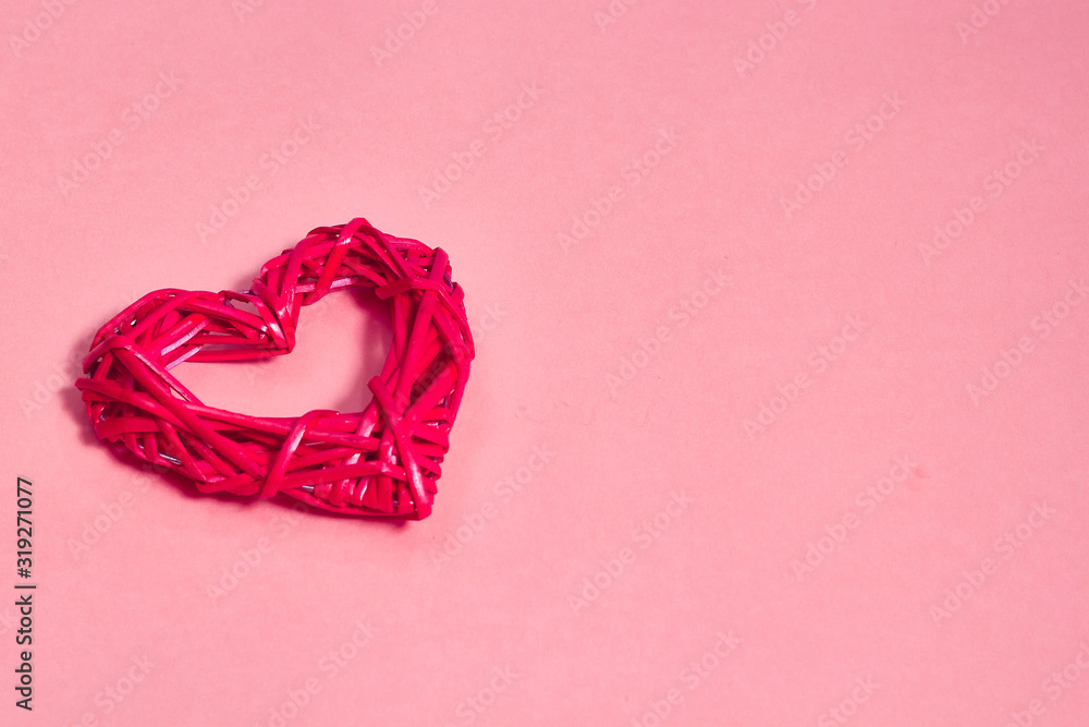 A braided heart on a pink background A braided heart on a pink background