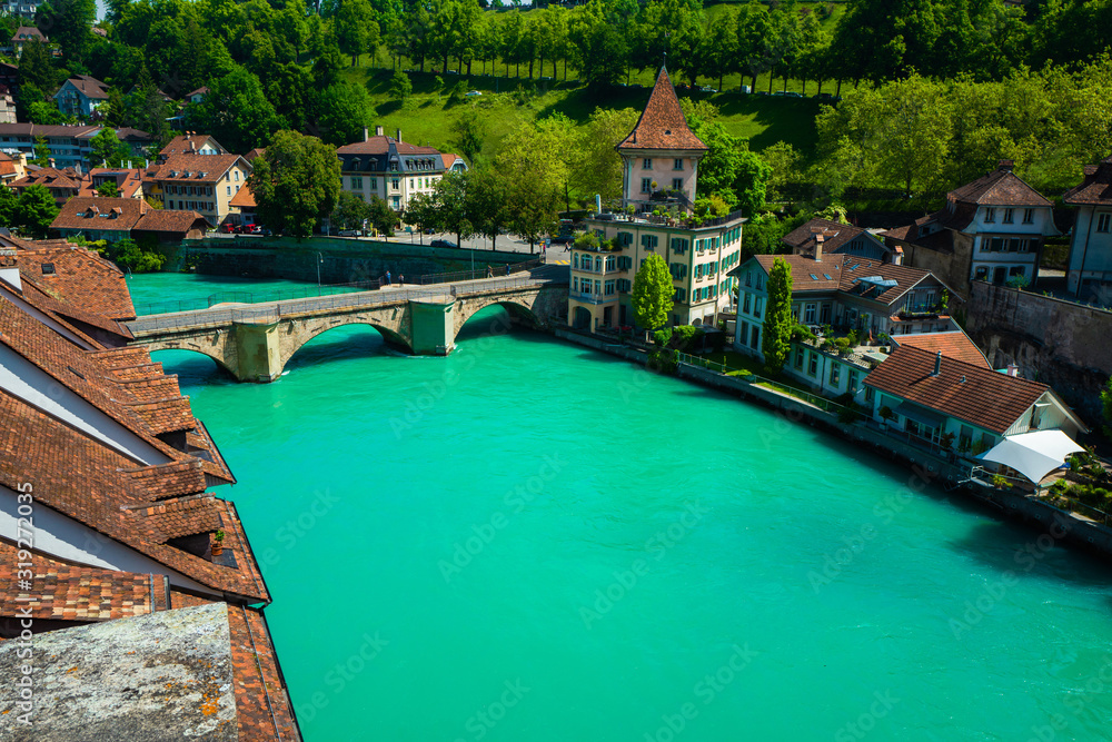 View of the old roofs of houses. Bridge over the river. Bern, Switzerland