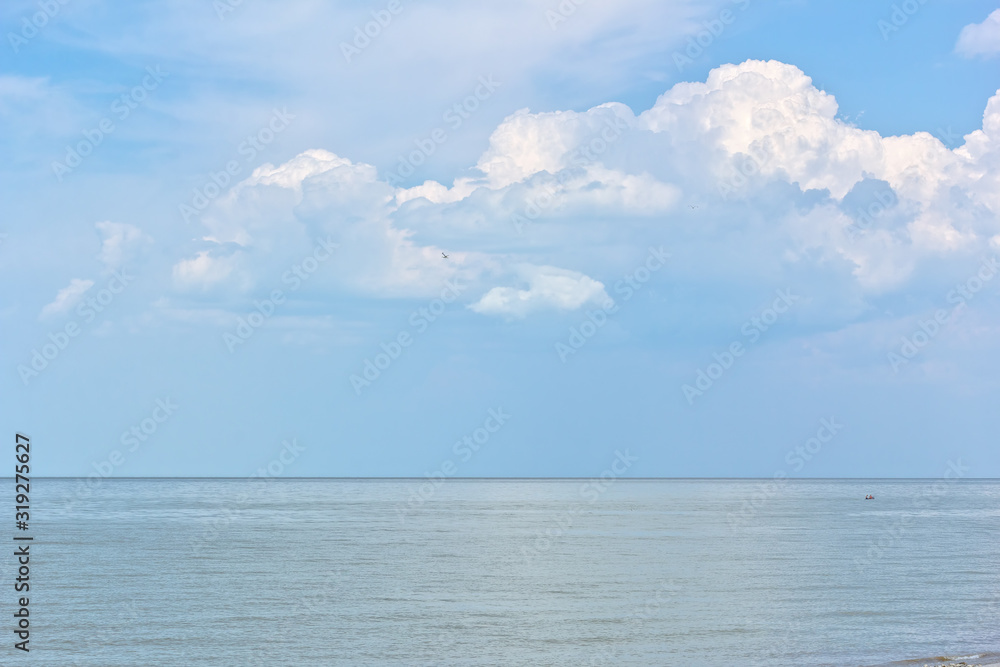 Serene seascape with white clouds above the sea