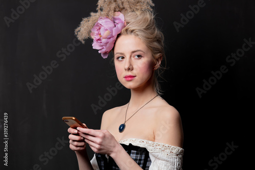 Beautiful blonde countess with mobile phone