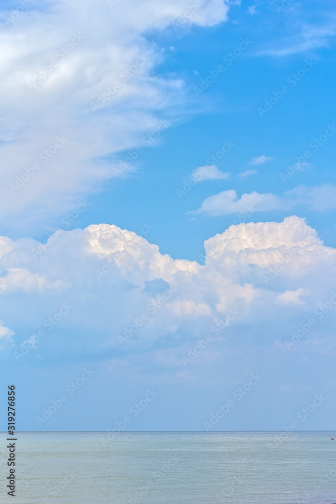 Picturesque seascape with white thunderclouds above the sea