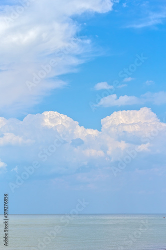 Picturesque seascape with white thunderclouds above the sea