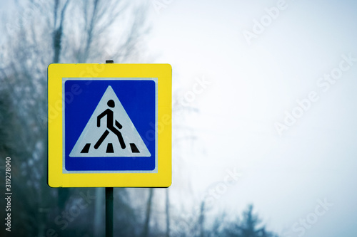 Pedestrian crossing sign on the side of the road. Road safety_