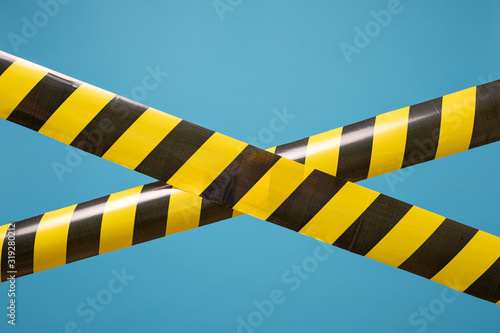 Black and yellow lines of barrier tape forbids passage. Concept of No entry.