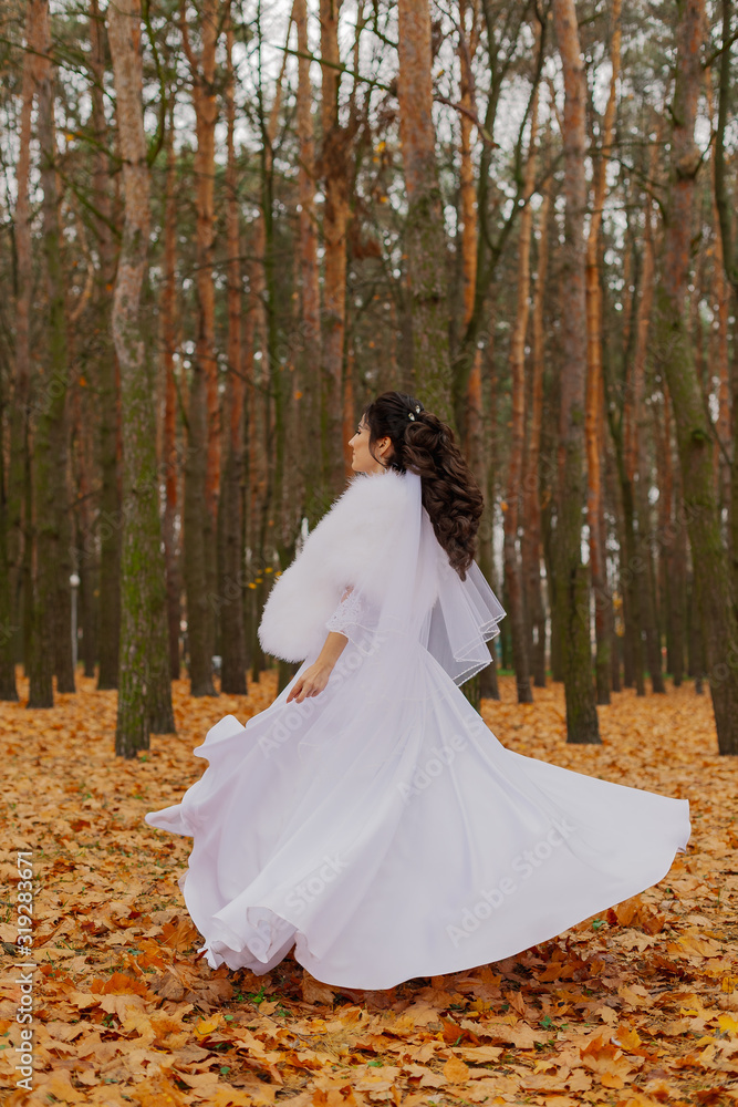 Happy beautiful bride in the autumn in the forest.