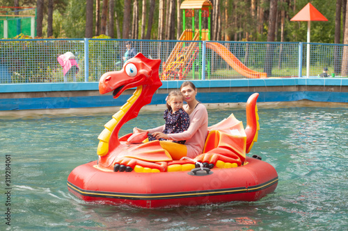 Mom and daughter ride on the water attraction © Stanislaw Mikulski