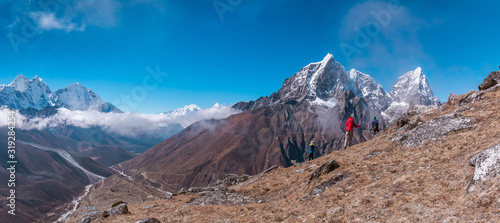 Panoramic view of backpackers facing to Tabuche Peak from the way to Nangkar Tshang View Point, Dingboche, Sagarmatha national park, Everest Base Camp 3 Passes Trek, Nepal photo
