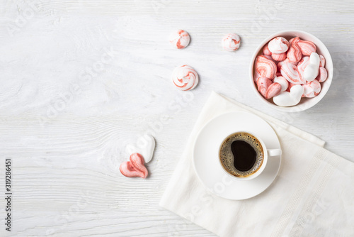 Tableau sur toile Beautiful romantic breakfast with coffee and meringue cookies in the shape of hearts and candys